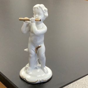 Vintage cherub playing flute